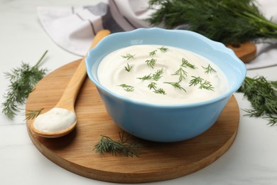 Photo of Tasty sour cream with dill on white table, closeup