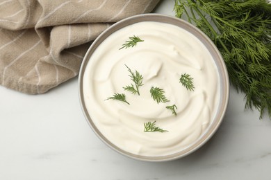 Photo of Tasty sour cream with dill on white table, flat lay