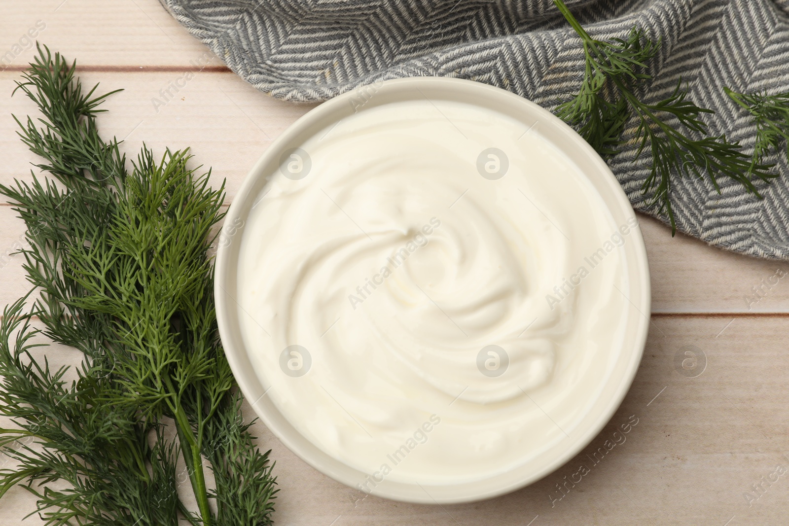 Photo of Tasty sour cream and dill on white wooden table, flat lay