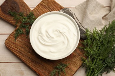 Photo of Tasty sour cream and dill on white wooden table, flat lay