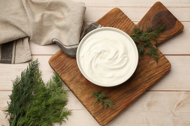 Photo of Tasty sour cream and dill on white wooden table, flat lay