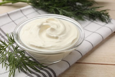 Photo of Tasty sour cream and dill on white wooden table, closeup