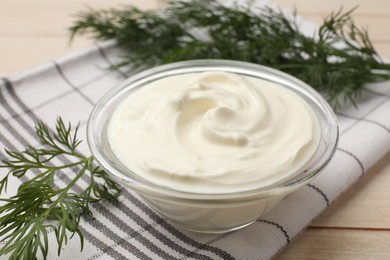 Photo of Tasty sour cream and dill on white wooden table, closeup