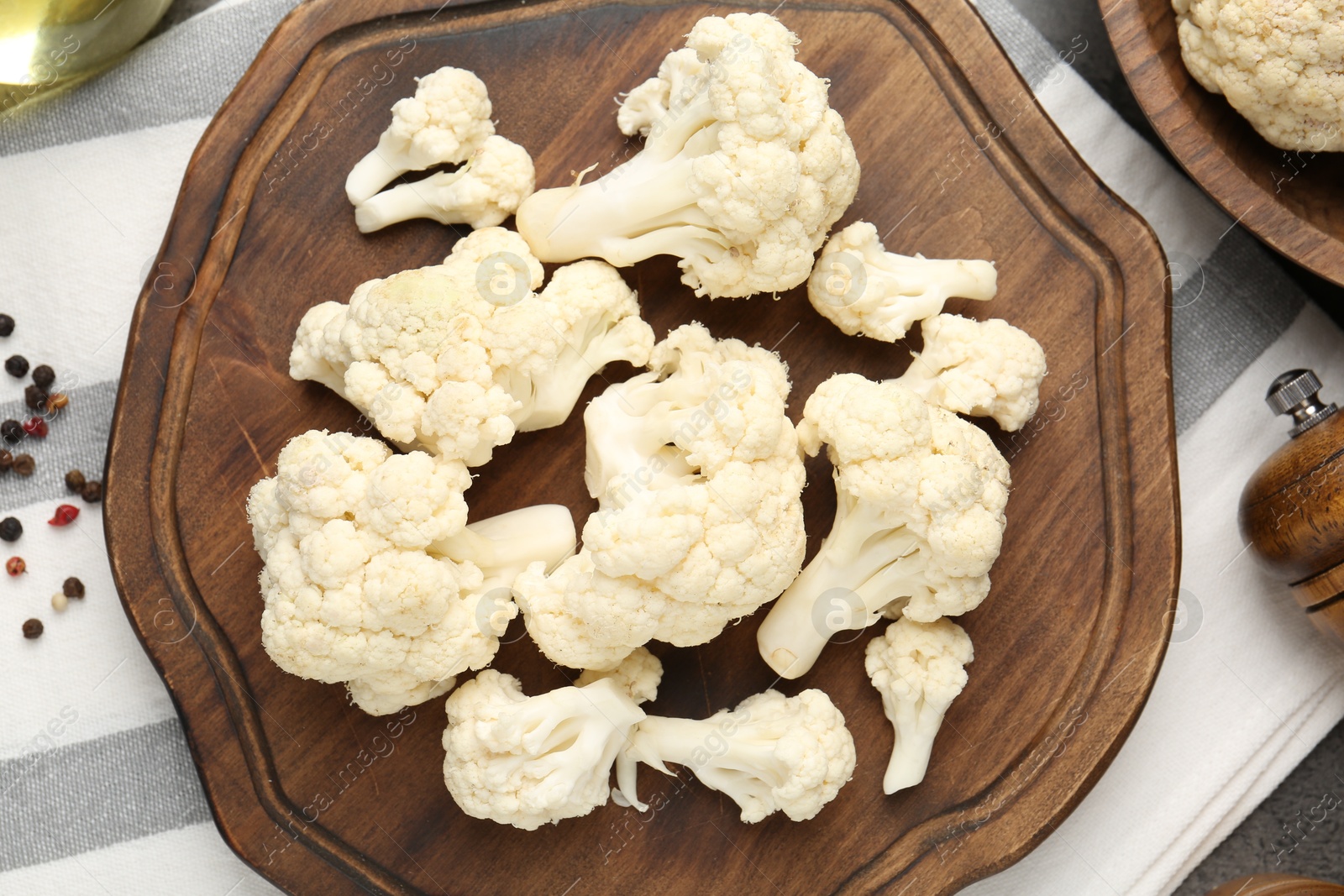 Photo of Fresh raw cauliflower florets and spices on table, flat lay