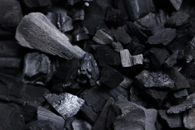 Photo of Pieces of black coals as background, top view