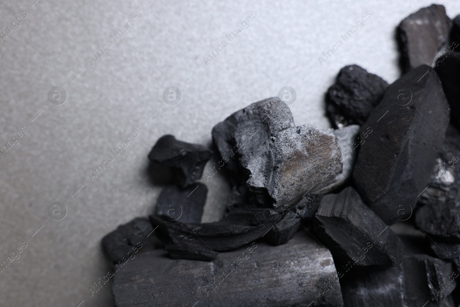 Pieces of black coals on grey table, top view. Space for text Photo of Pieces of black coals on grey table, top view. Space for text