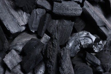 Photo of Pieces of black coals as background, top view
