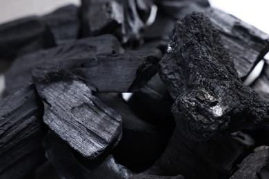 Photo of Pieces of black coals as background, closeup