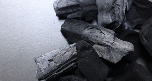Photo of Pieces of black coals on table, above view. Space for text