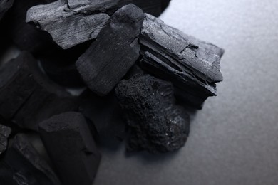 Photo of Pieces of black coals on table, above view