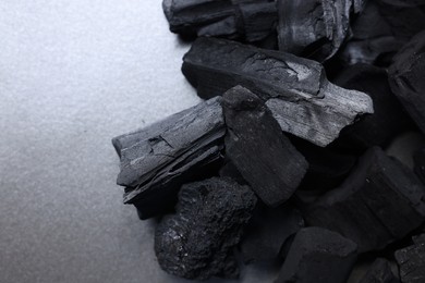 Photo of Pieces of black coals on table, top view. Space for text