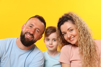 Photo of Portrait of happy family on yellow background