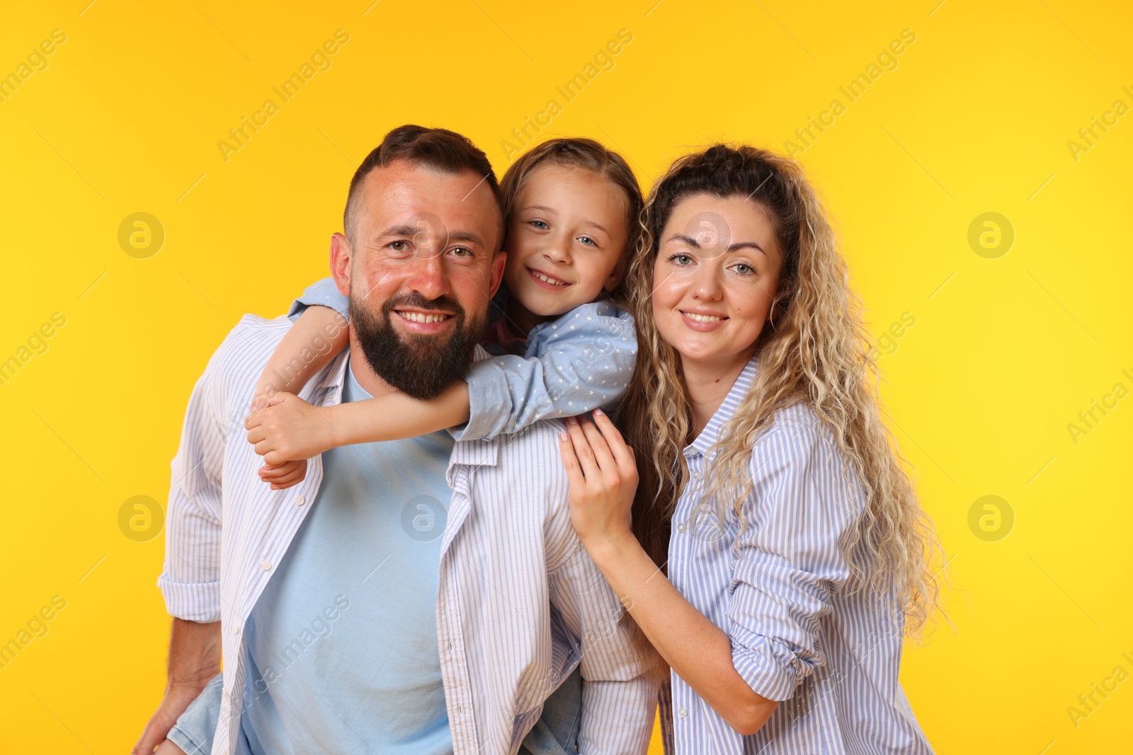 Portrait of happy family on yellow background Photo of Portrait of happy family on yellow background