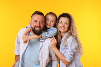 Photo of Portrait of happy family on yellow background