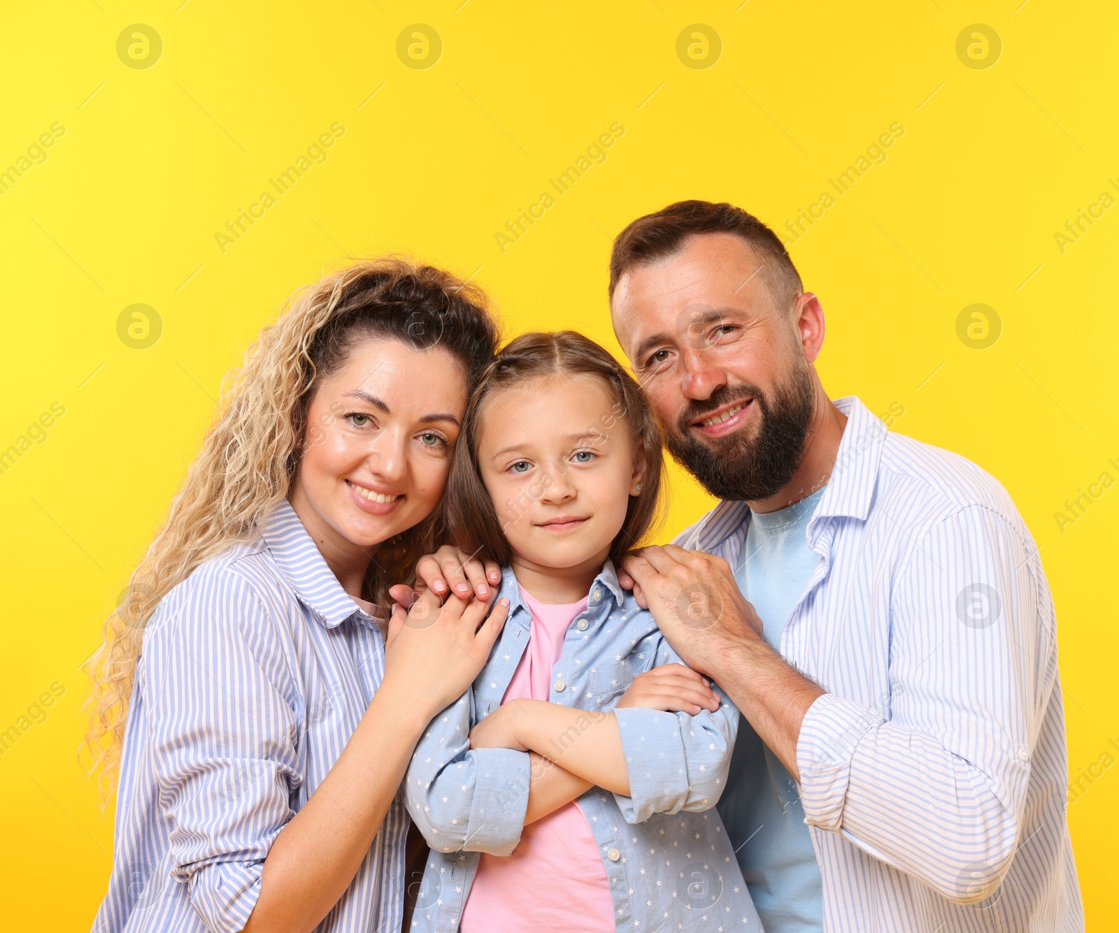 Portrait of happy family on yellow background Photo of Portrait of happy family on yellow background