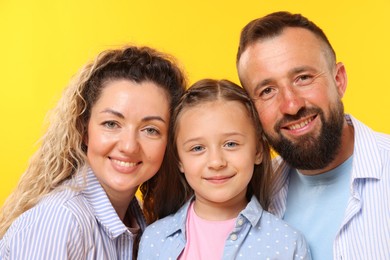 Photo of Portrait of happy family on yellow background