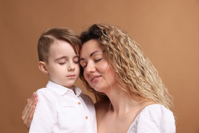 Photo of Family. Mother and her son on beige background