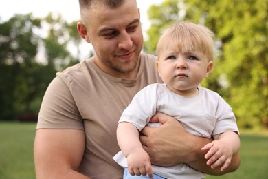 Photo of Dad with his cute newborn baby outdoors. Happy Father's Day