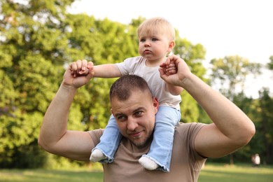Photo of Dad with his cute newborn baby outdoors. Happy Father's Day
