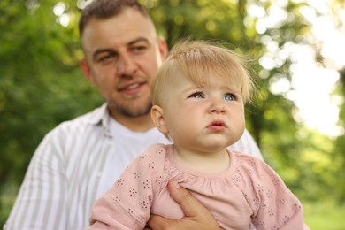 Photo of Dad and his newborn baby outdoors, closeup. Happy Father's Day