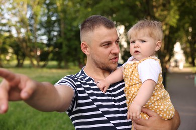 Photo of Dad and his newborn baby outdoors. Happy Father's Day