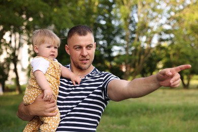 Photo of Dad and his newborn baby outdoors. Happy Father's Day