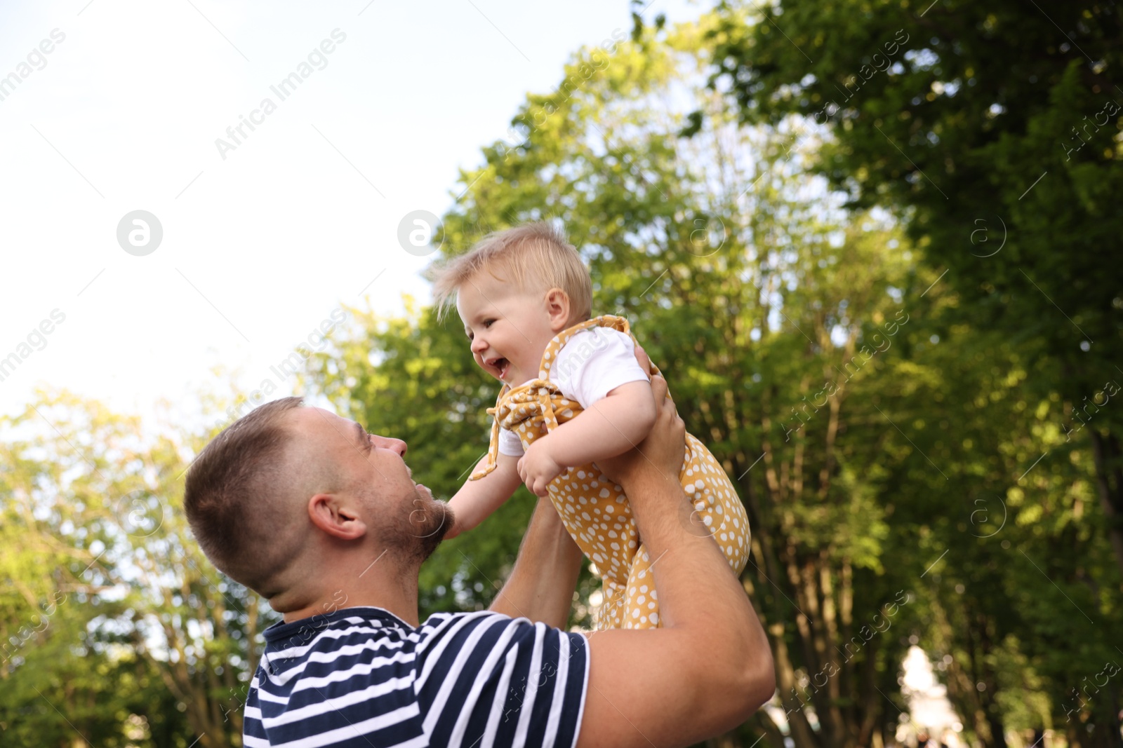 Dad having fun with his newborn baby outdoors. Happy Father's Day Photo of Dad having fun with his newborn baby outdoors. Happy Father's Day