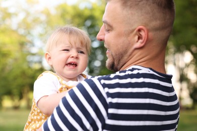 Photo of Dad and his newborn baby outdoors, closeup. Happy Father's Day