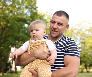 Photo of Dad and his newborn baby outdoors. Happy Father's Day
