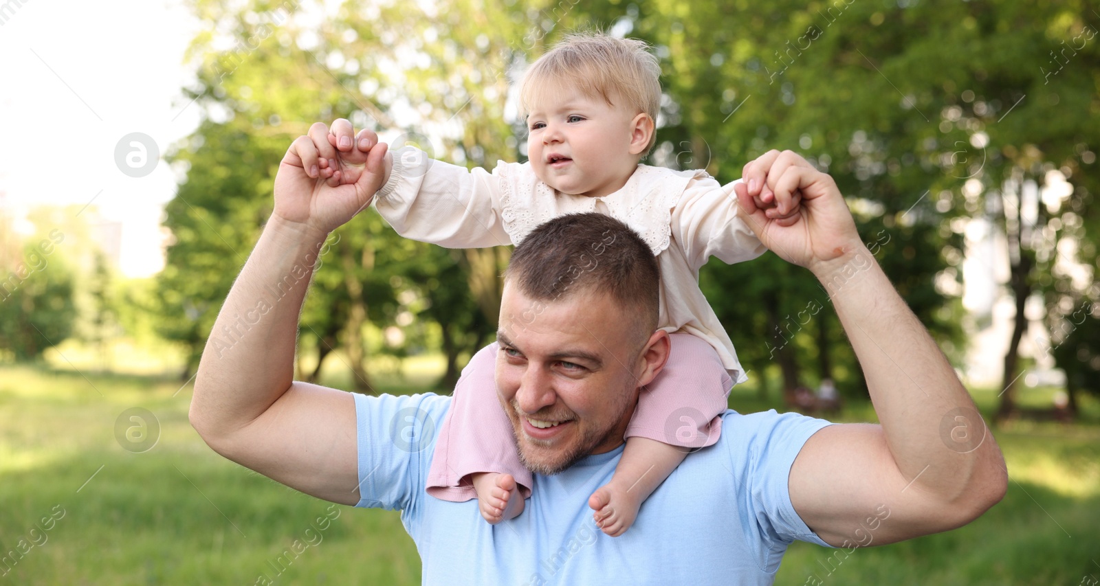 Smiling dad and his newborn baby playing outdoors. Happy Father's Day Photo of Smiling dad and his newborn baby playing outdoors. Happy Father's Day