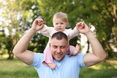 Photo of Smiling dad and his newborn baby playing outdoors. Happy Father's Day