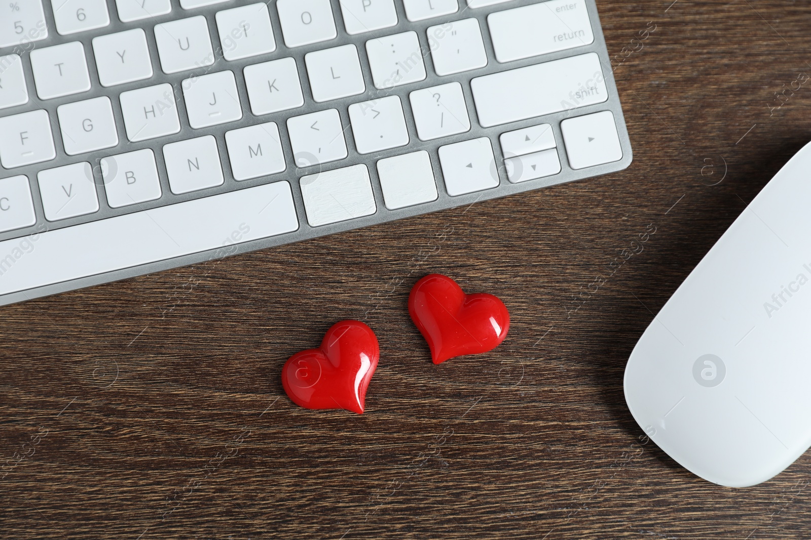 Decorative hearts, computer keyboard and mouse on wooden table, flat lay. Online dating site Photo of Decorative hearts, computer keyboard and mouse on wooden table, flat lay. Online dating site