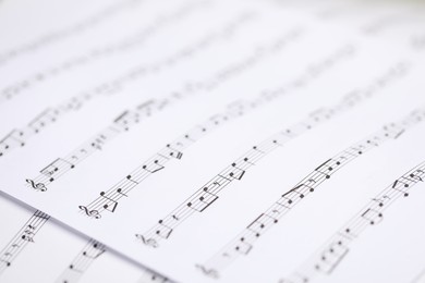 Photo of Sheets with musical notes as background, closeup