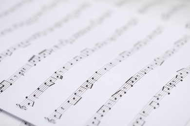 Photo of Sheets with musical notes as background, closeup