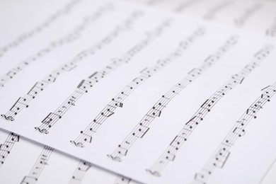 Photo of Sheets with musical notes as background, closeup