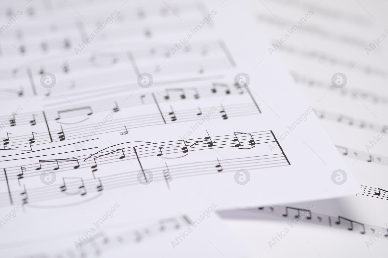 Sheets with musical notes as background, closeup Photo of Sheets with musical notes as background, closeup
