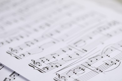 Photo of Sheets with musical notes as background, closeup