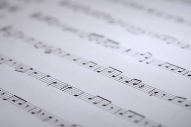 Photo of Sheet with musical notes as background, closeup