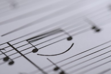 Photo of Sheet with musical notes as background, closeup