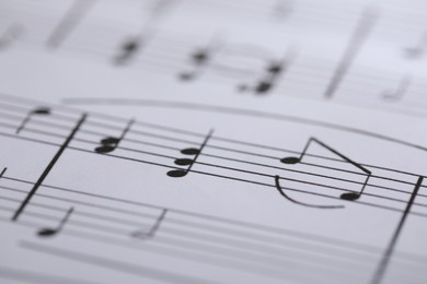 Photo of Sheet with musical notes as background, closeup