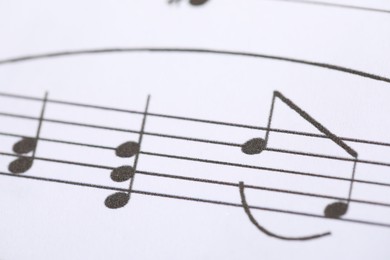 Photo of Sheet with musical notes as background, closeup
