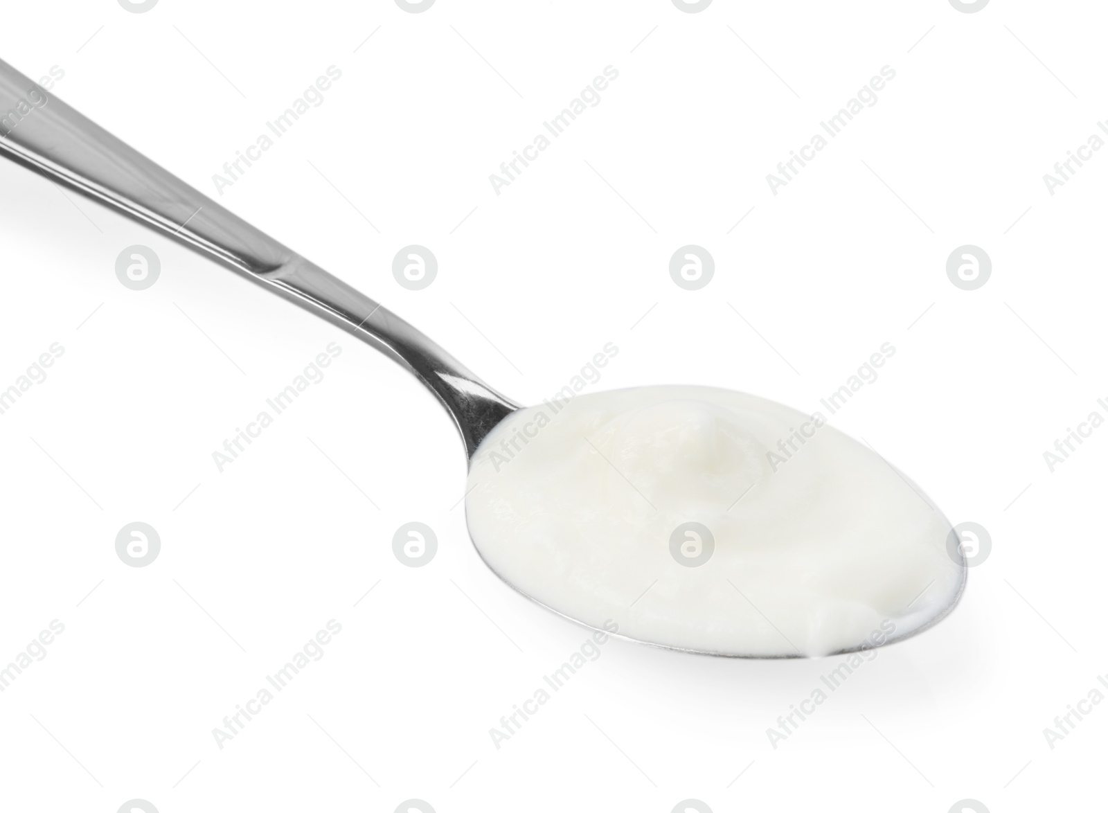 Photo of Tasty yoghurt in spoon isolated on white