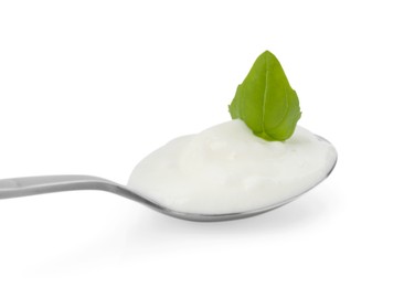 Photo of Tasty yoghurt with basil in spoon isolated on white