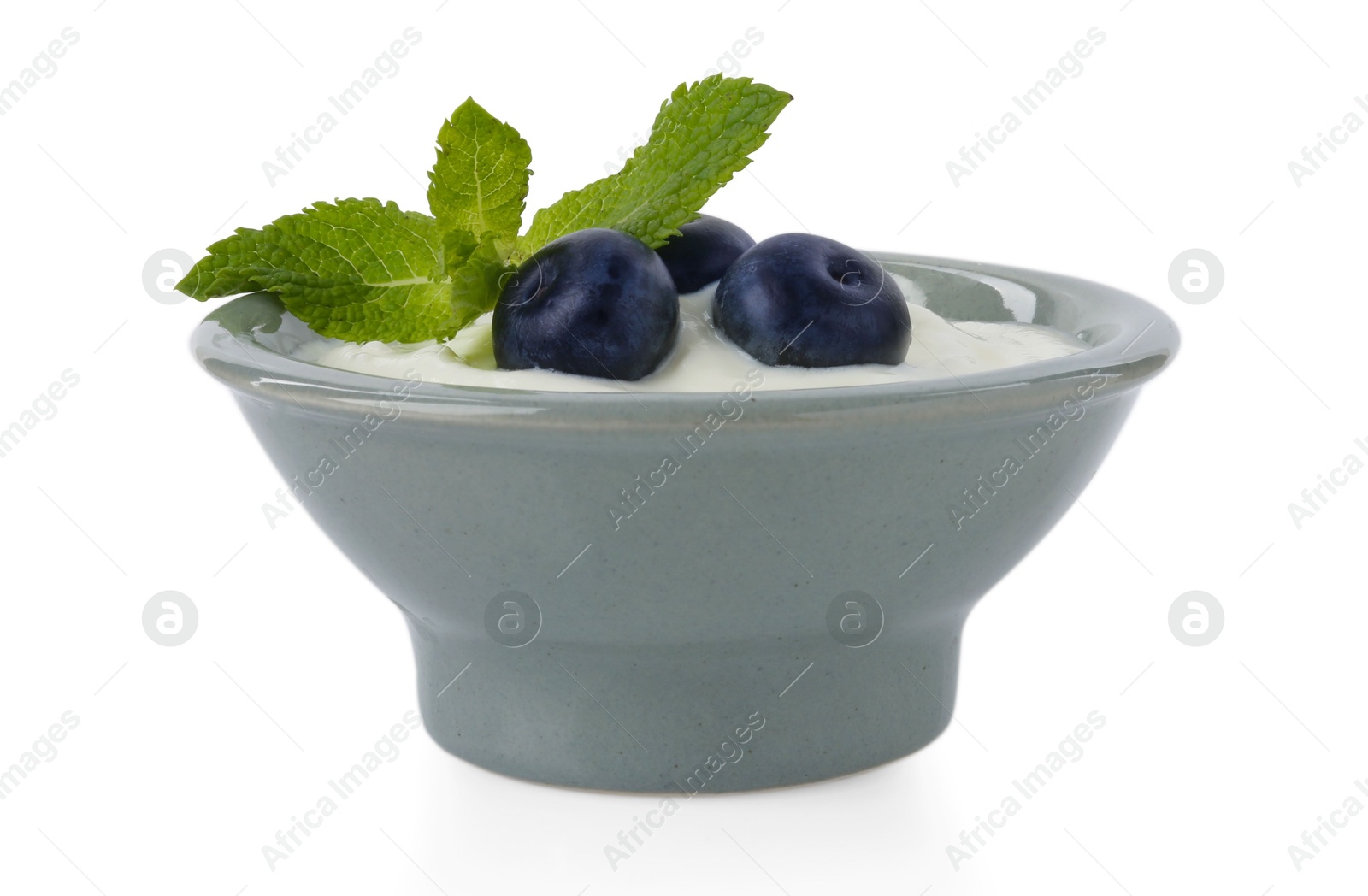 Photo of Tasty yoghurt with blueberries and mint in bowl isolated on white