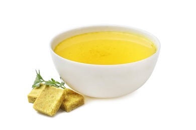 Photo of Aromatic bouillon cubes, broth and parsley isolated on white