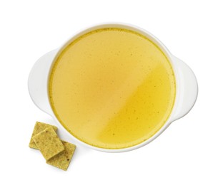 Photo of Aromatic bouillon cubes and broth isolated on white, top view