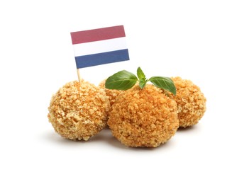 Photo of Delicious fried croquette balls, basil and small flag of Netherlands isolated on white