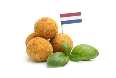 Photo of Delicious fried croquette balls, basil and small flag of Netherlands isolated on white