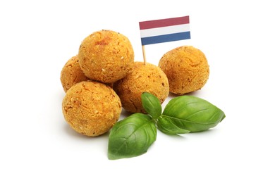 Photo of Delicious fried croquette balls, basil and small flag of Netherlands isolated on white