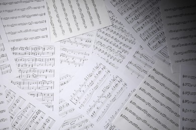 Photo of Sheets with musical notes as background, top view